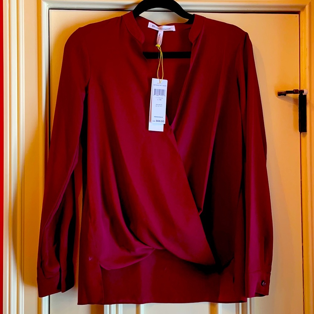 BCBGeneration maroon wrap blouse in case polyester silk.